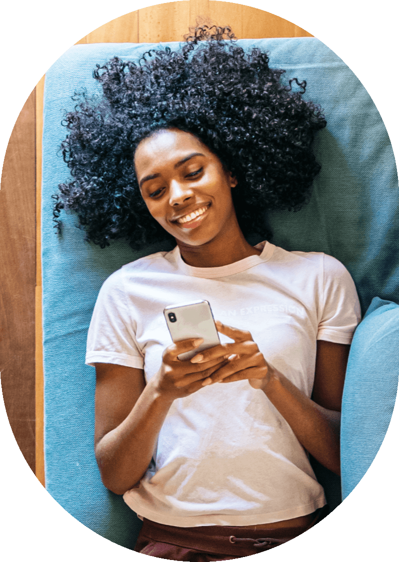 woman lying down looking at phone